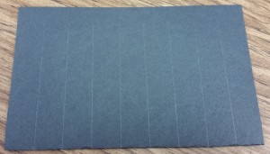 Close up of the folded paper with pre-drawn lines for cutting